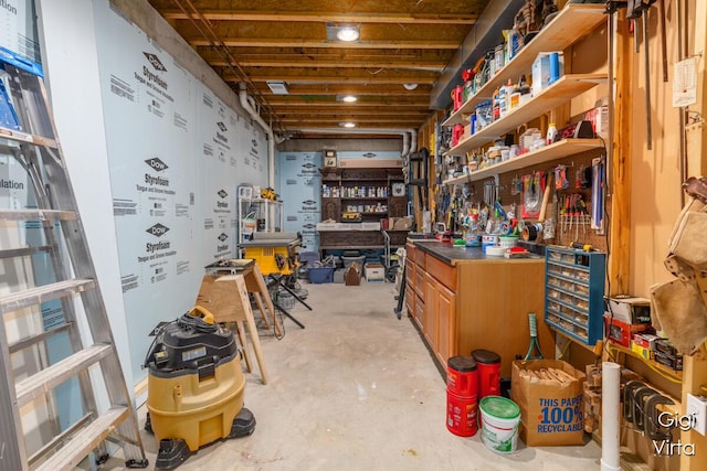 misc room featuring unfinished concrete flooring and a workshop area