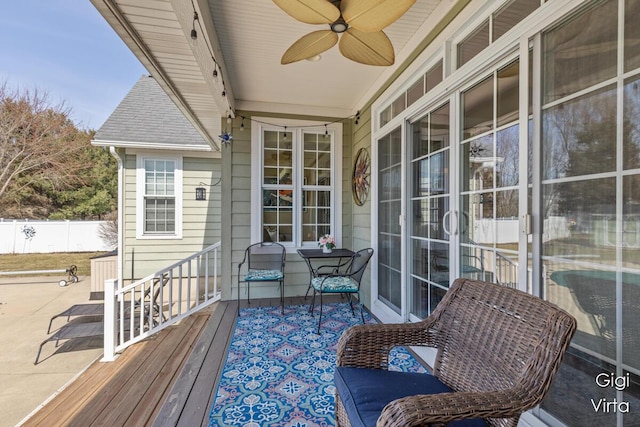 wooden terrace featuring a ceiling fan and fence