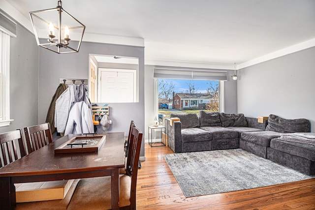 living room featuring a chandelier and light wood-style flooring