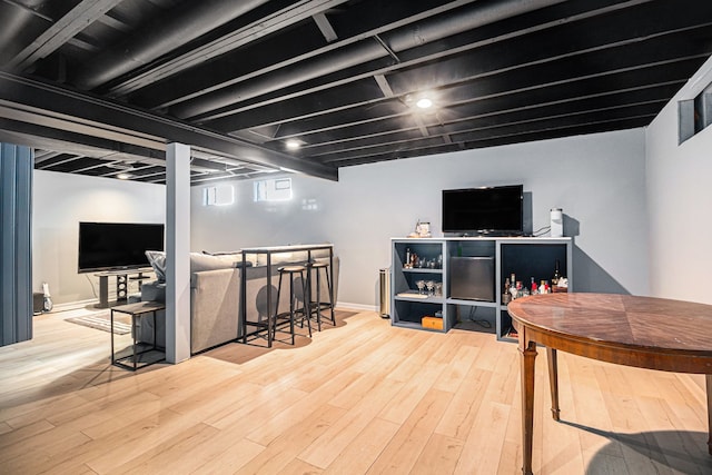 interior space featuring a dry bar, baseboards, and wood finished floors