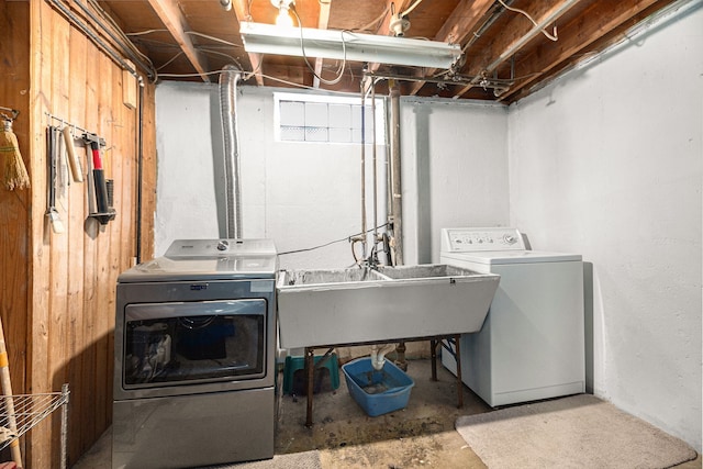 laundry room featuring washing machine and clothes dryer, laundry area, and a sink