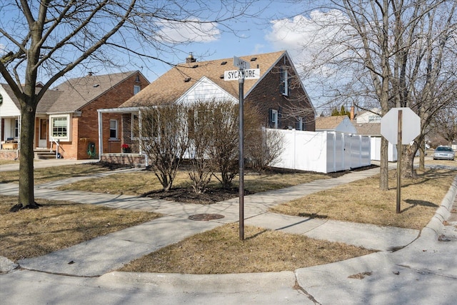 view of front of property with fence and brick siding