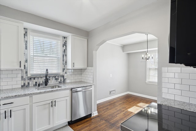 kitchen featuring tasteful backsplash, a sink, stainless steel dishwasher, white cabinets, and dark wood-style flooring