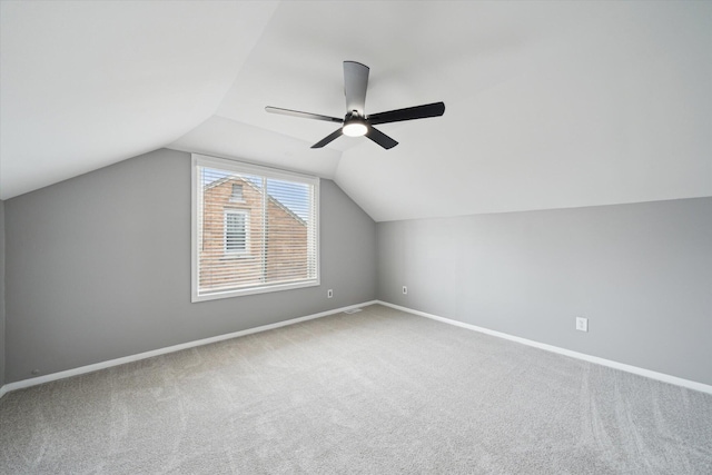 bonus room featuring baseboards, lofted ceiling, a ceiling fan, and carpet flooring