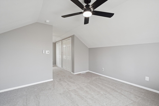 bonus room with baseboards, carpet, lofted ceiling, and ceiling fan