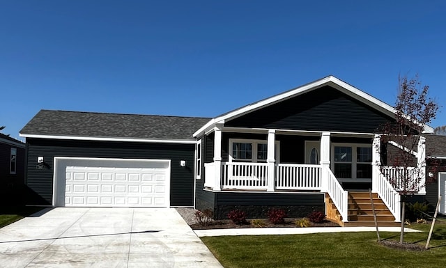 view of front facade featuring a garage, covered porch, concrete driveway, and a front lawn