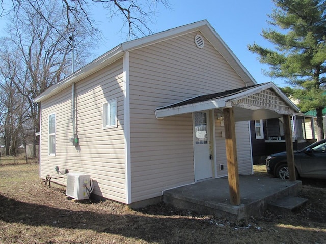 view of property exterior featuring ac unit and a carport