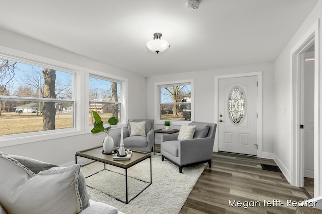 living room featuring dark wood-style floors and baseboards