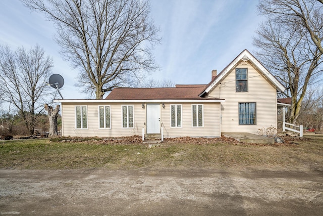 traditional-style home featuring a chimney