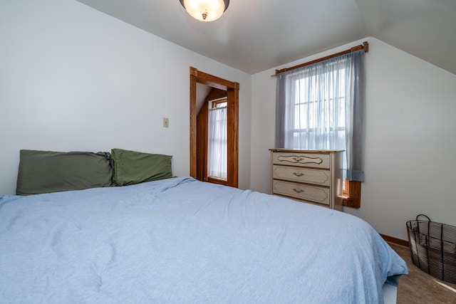 carpeted bedroom featuring vaulted ceiling