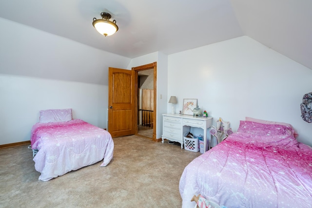 bedroom with vaulted ceiling, light colored carpet, and baseboards