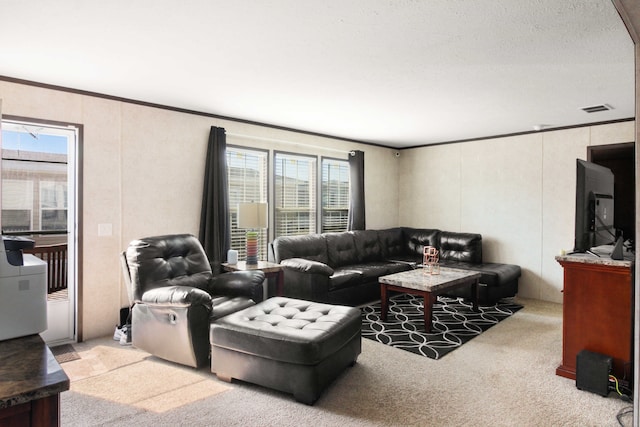 living room featuring visible vents, ornamental molding, and carpet flooring