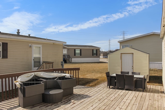 deck with outdoor dining space, an outbuilding, a shed, and entry steps