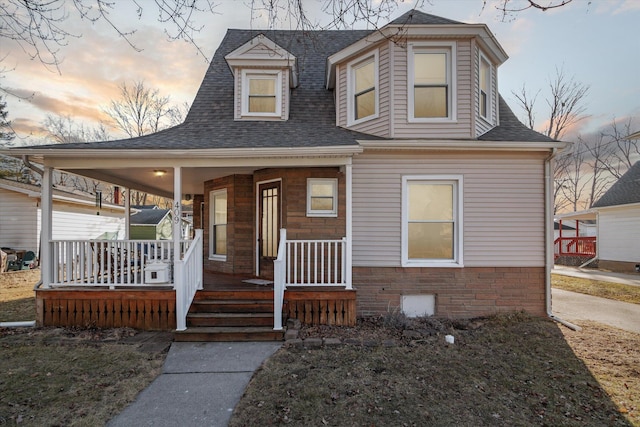 view of front facade with a porch and a shingled roof