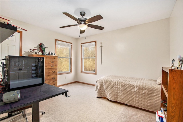 bedroom with baseboards, a ceiling fan, and carpet flooring