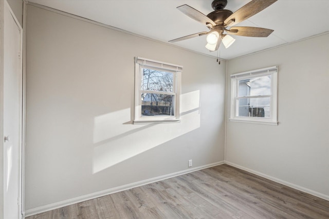 unfurnished room with light wood finished floors, ceiling fan, and baseboards