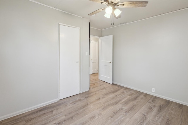 empty room with visible vents, ceiling fan, baseboards, and light wood-style floors