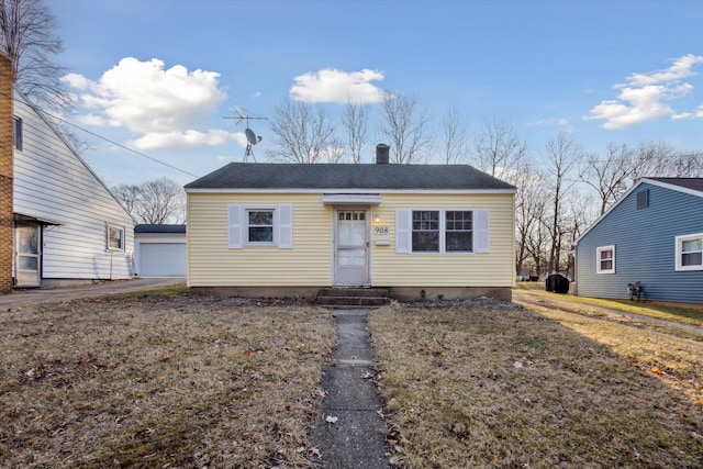 bungalow featuring a garage and a chimney