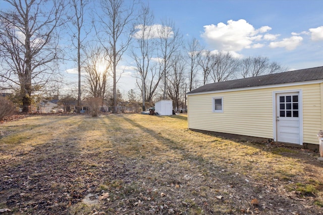 view of yard with an outdoor structure and a shed