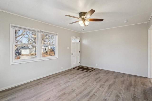 entryway featuring crown molding, wood finished floors, baseboards, and ceiling fan