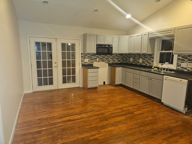 kitchen featuring black microwave, dishwasher, vaulted ceiling, french doors, and a sink