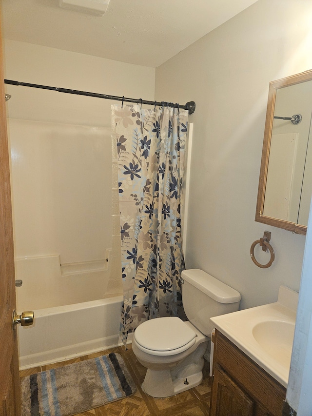 bathroom featuring toilet, shower / bath combo, and vanity