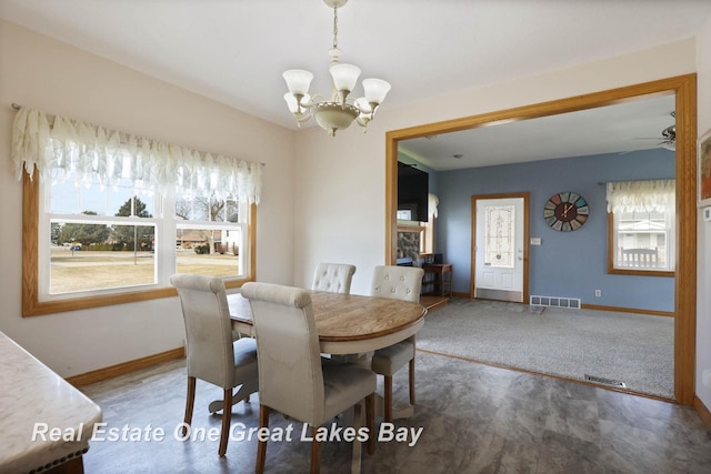 dining area featuring baseboards, visible vents, and a chandelier