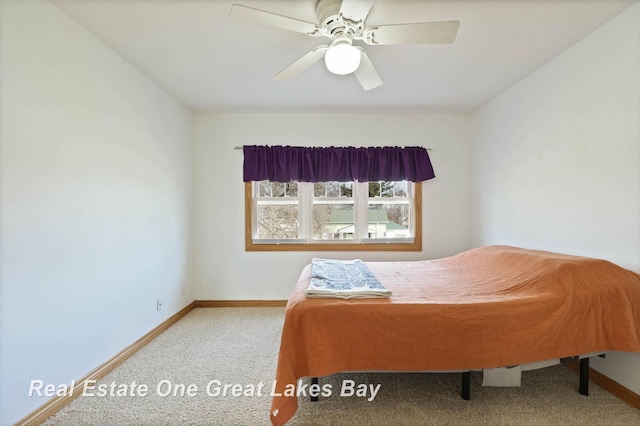 bedroom featuring baseboards and ceiling fan