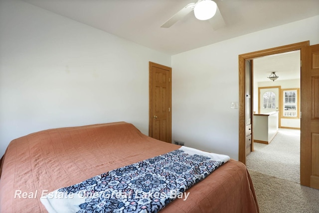 bedroom with visible vents, a ceiling fan, and carpet floors