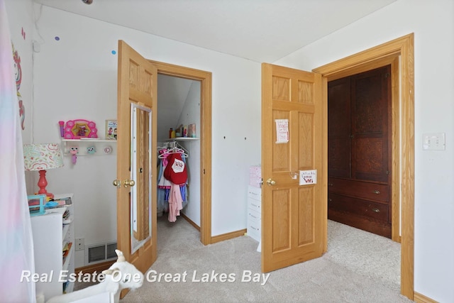 carpeted bedroom with baseboards and visible vents