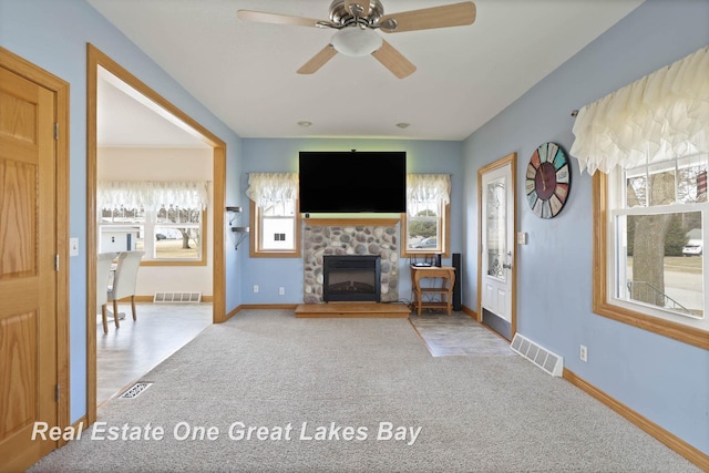 unfurnished living room featuring visible vents, carpet flooring, and a fireplace