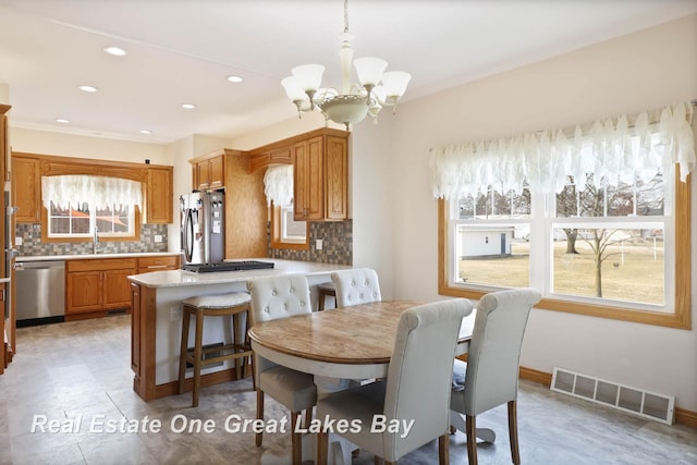 dining area with a notable chandelier, recessed lighting, visible vents, and baseboards