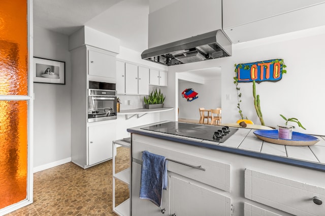 kitchen with wall chimney exhaust hood, white cabinets, stainless steel oven, black electric cooktop, and baseboards