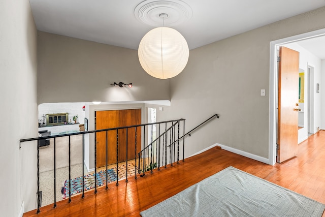 stairway featuring baseboards and hardwood / wood-style flooring