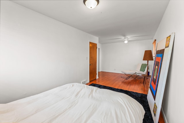 bedroom featuring visible vents, wood finished floors, and baseboards