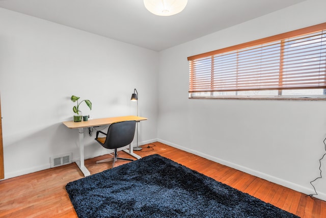 office area featuring visible vents, baseboards, and hardwood / wood-style floors