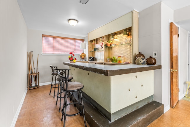 bar with a dry bar and baseboards