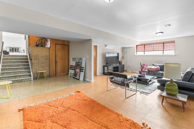 living room with stairs and baseboards