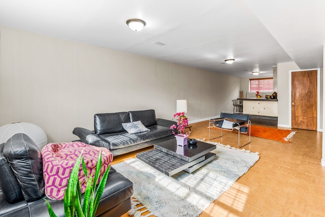 living area featuring parquet flooring, visible vents, and baseboards