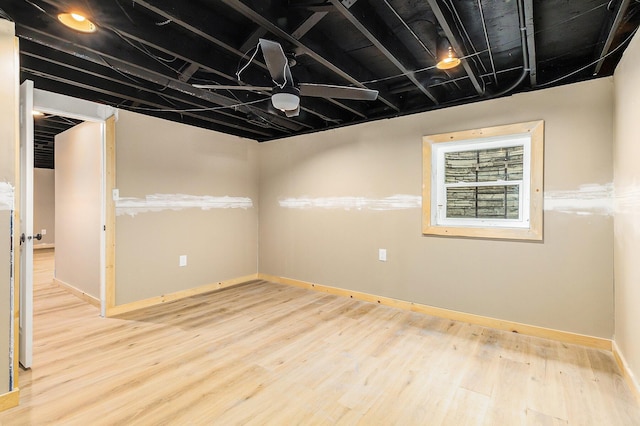 below grade area featuring baseboards and wood finished floors