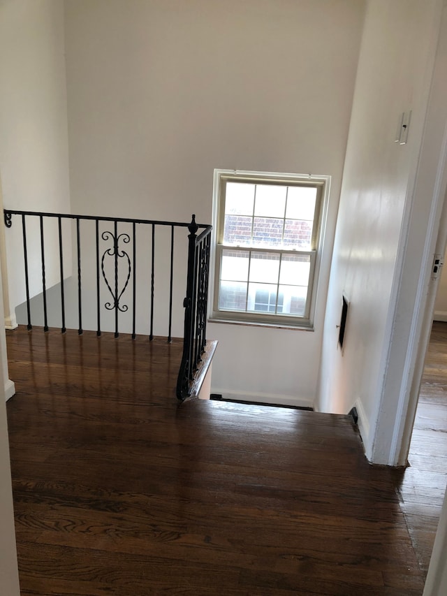 stairs featuring wood finished floors