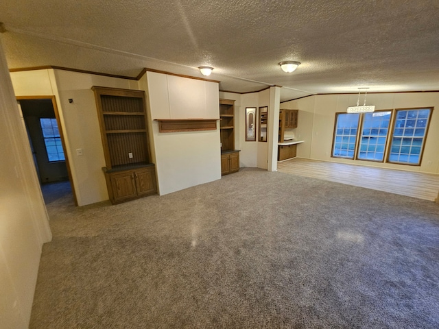 unfurnished living room featuring a textured ceiling, carpet floors, and ornamental molding