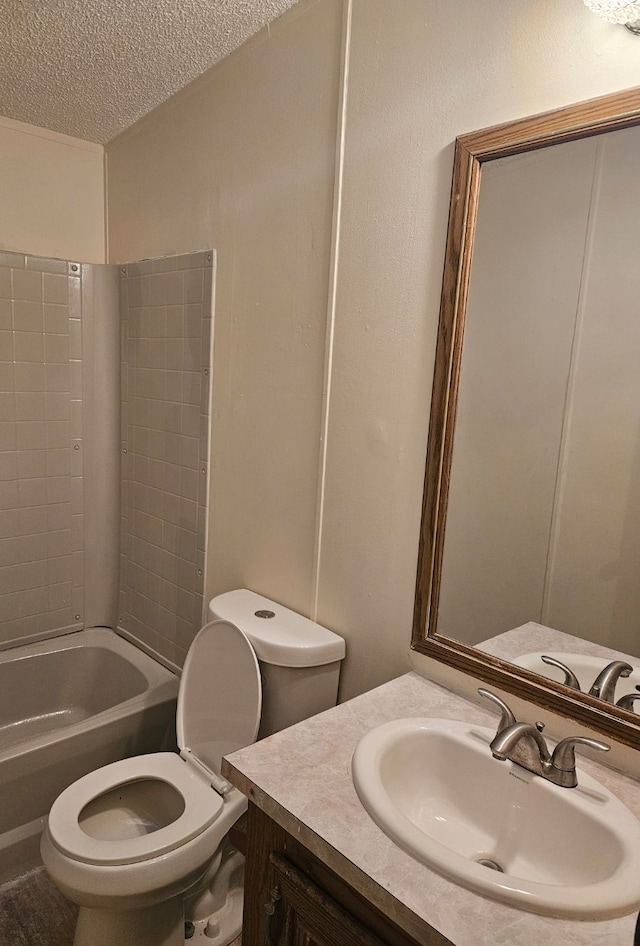 bathroom featuring toilet, a textured ceiling, vanity, and bathtub / shower combination