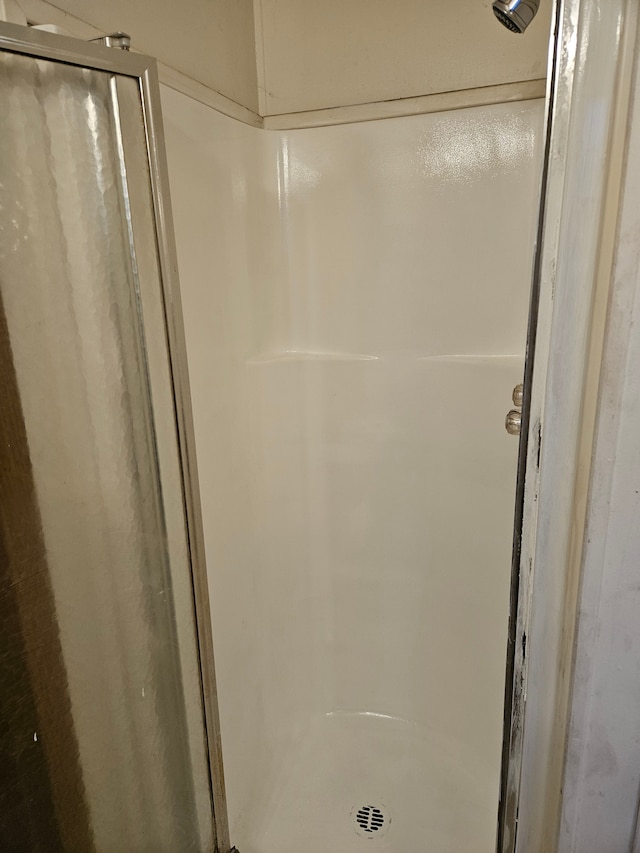 full bath with a shower stall