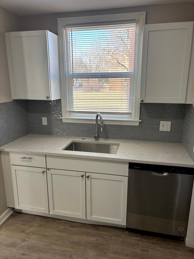 kitchen with a sink, white cabinetry, and stainless steel dishwasher