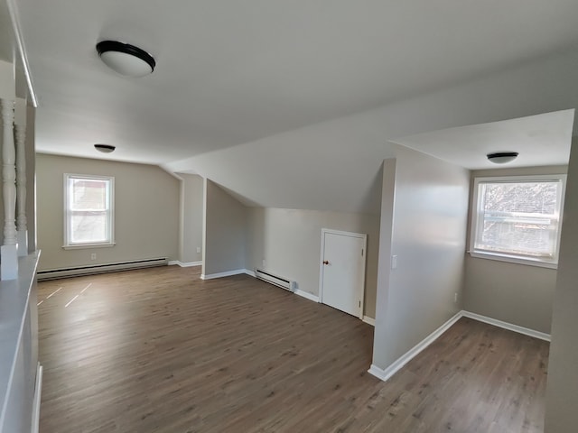 bonus room with vaulted ceiling, wood finished floors, and a baseboard radiator