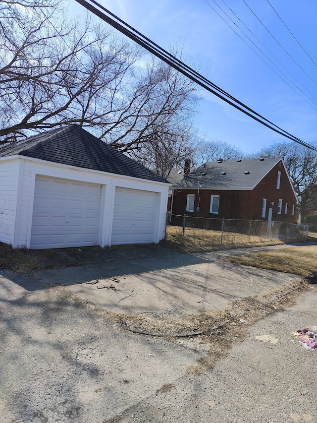 detached garage featuring fence