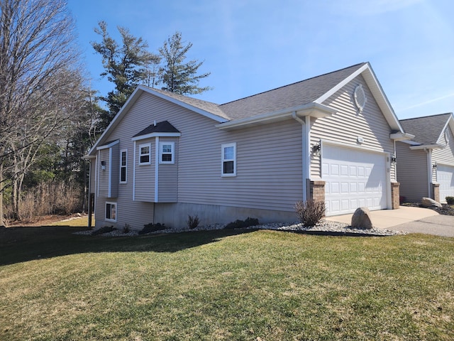 view of home's exterior with concrete driveway, a lawn, a garage, and a shingled roof