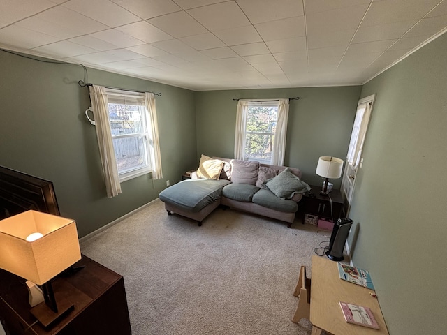 carpeted living room featuring baseboards