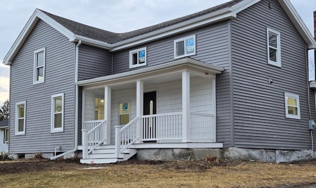 traditional-style home featuring covered porch